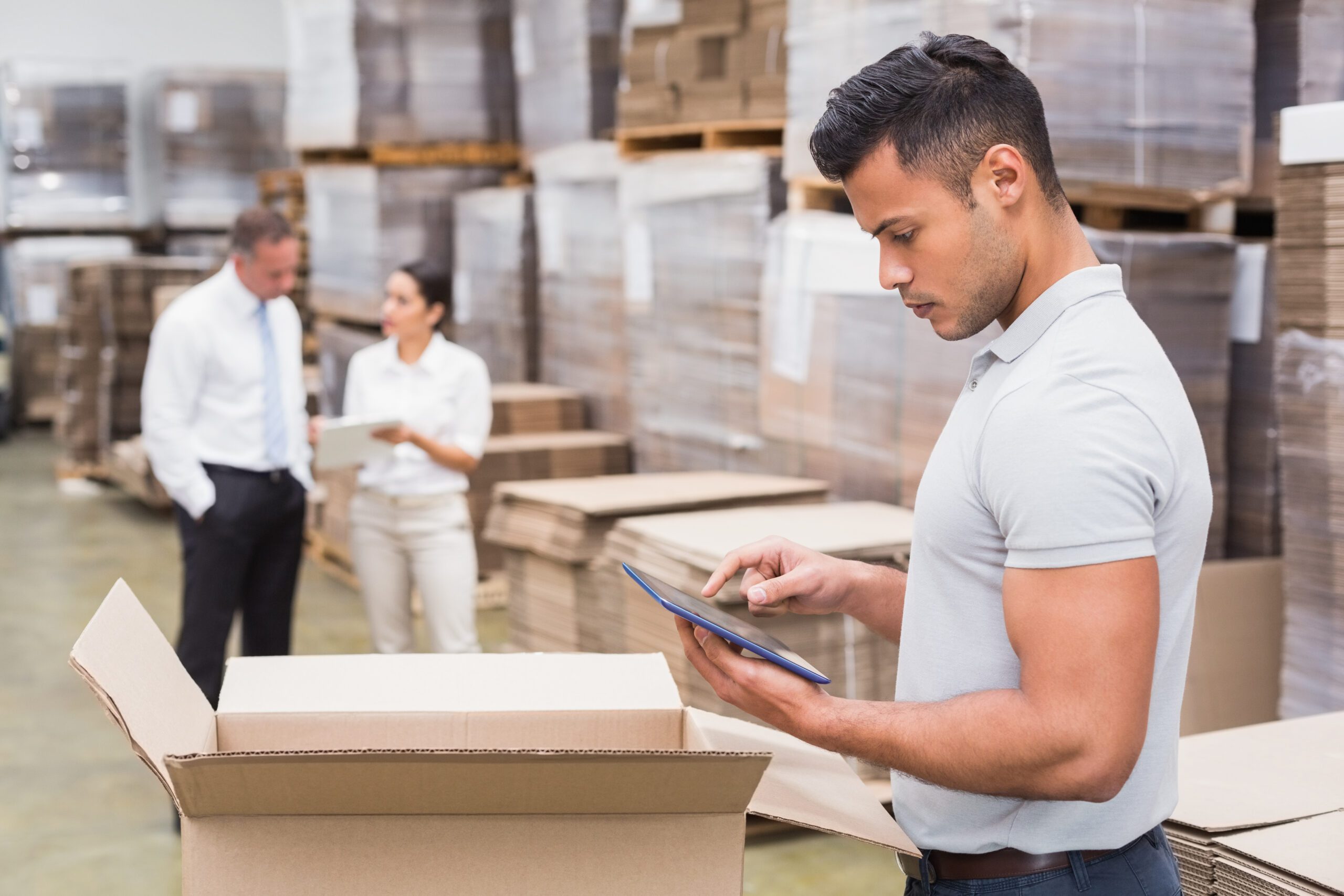 Male manager using a digital tablet in a warehouse