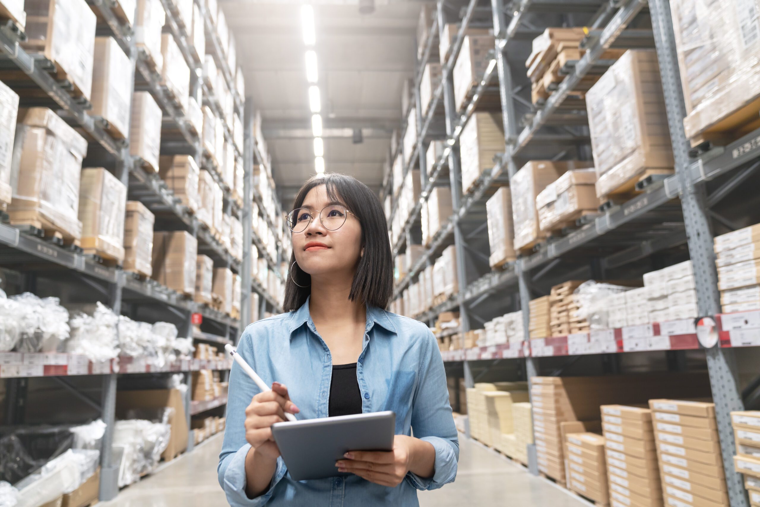 Female Employee Looking Up At Inventory