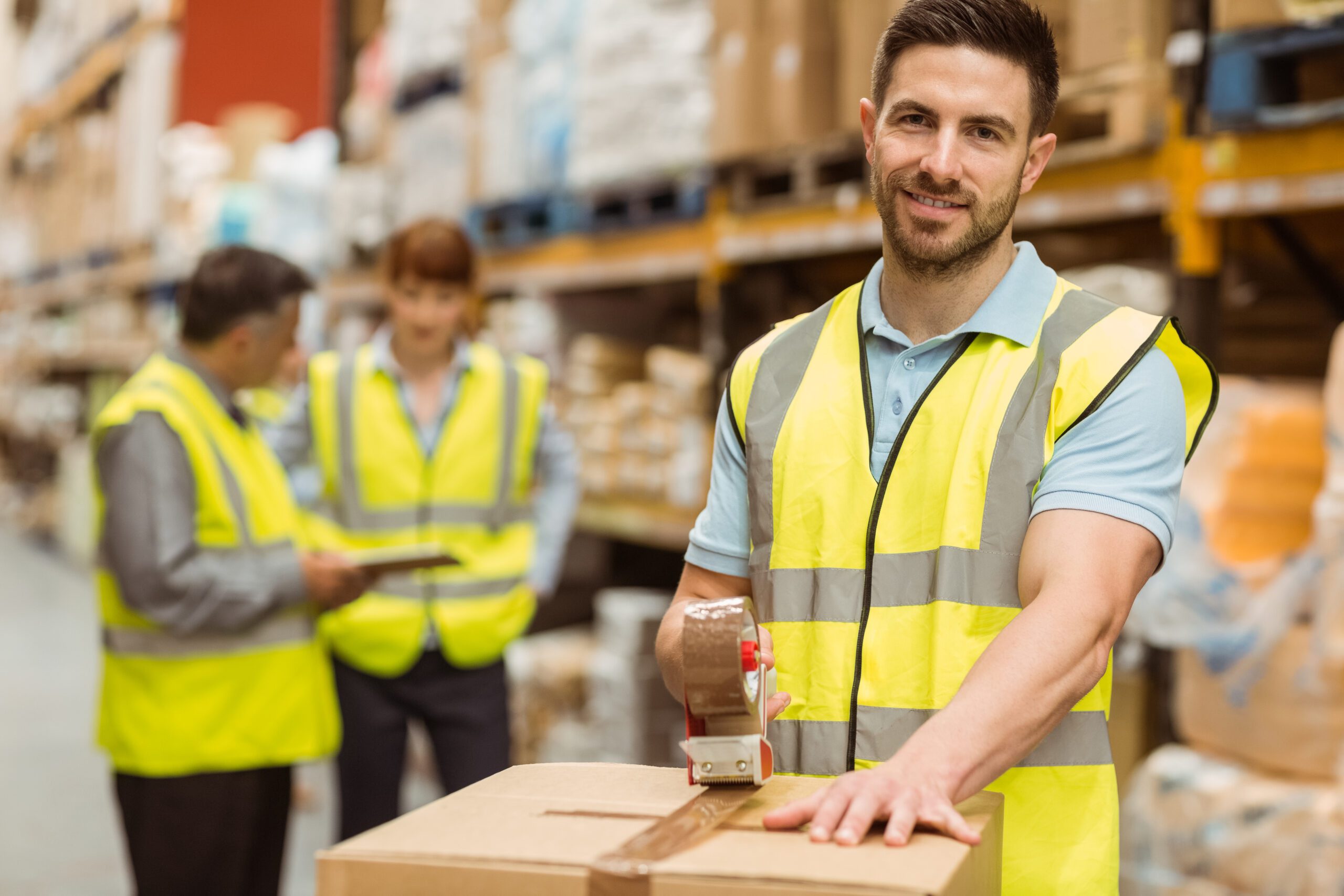 Smiling Warehouse Workers Preparing a Shipment